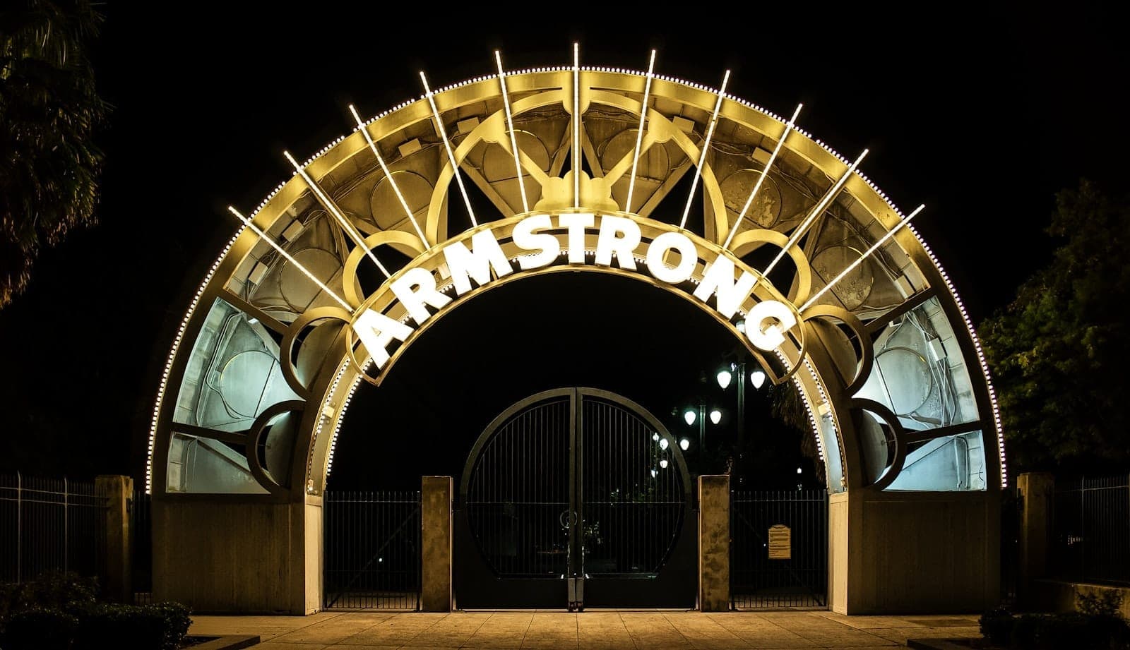 Nächtliche Ansicht des beleuchteten Eingangsbogens des Armstrong Park, ein Tor zum historischen Congo Square im Tremé-Viertel von New Orleans.