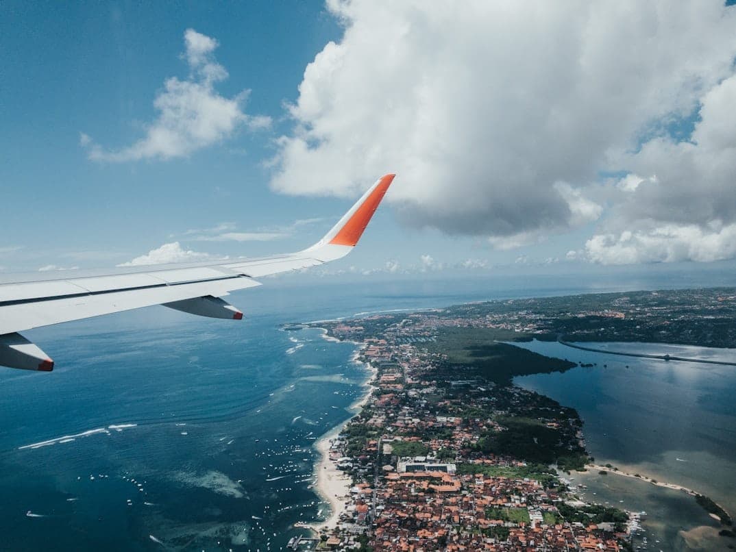 Aerial view of Bali coastline seen from airplane window during arrival to the island