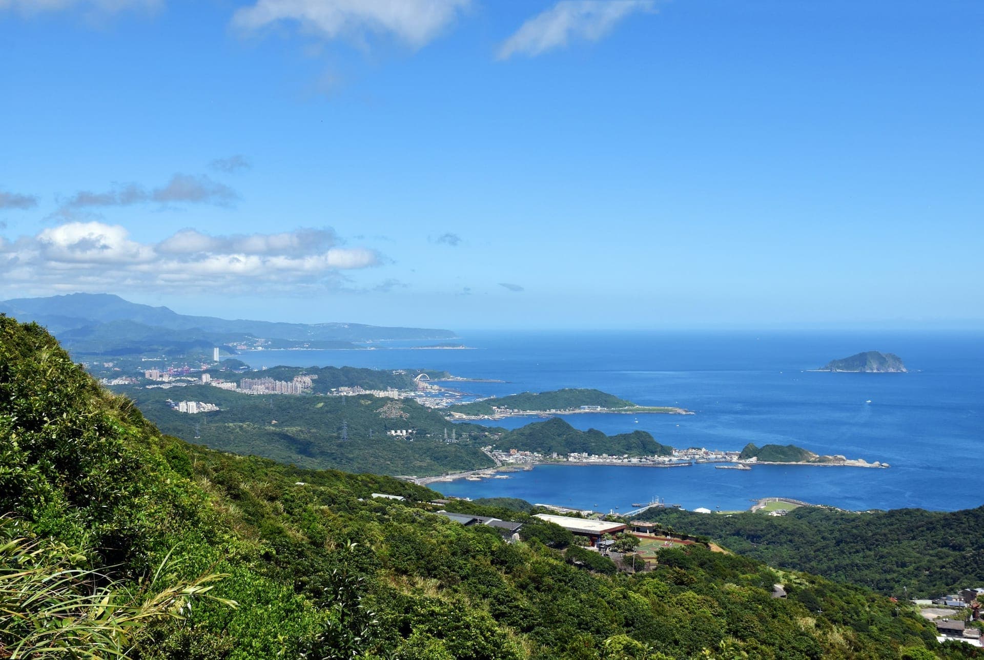 Coastal hiking trail in Hong Kong with green hills, open views, and minimal development, Hong Kong