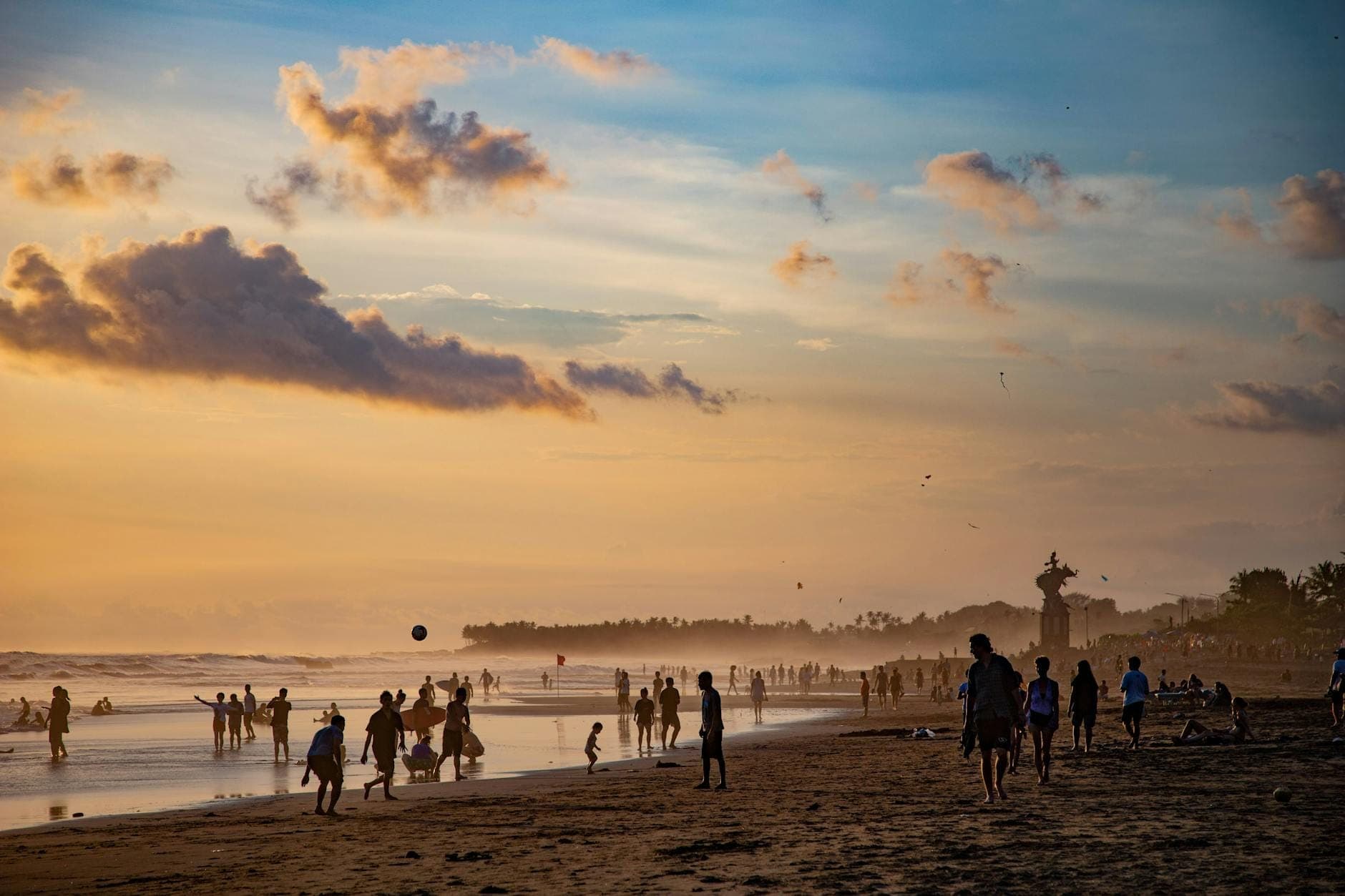 Serene Echo Beach sunset scene with calm waters and black sand shoreline in Canggu, Bali