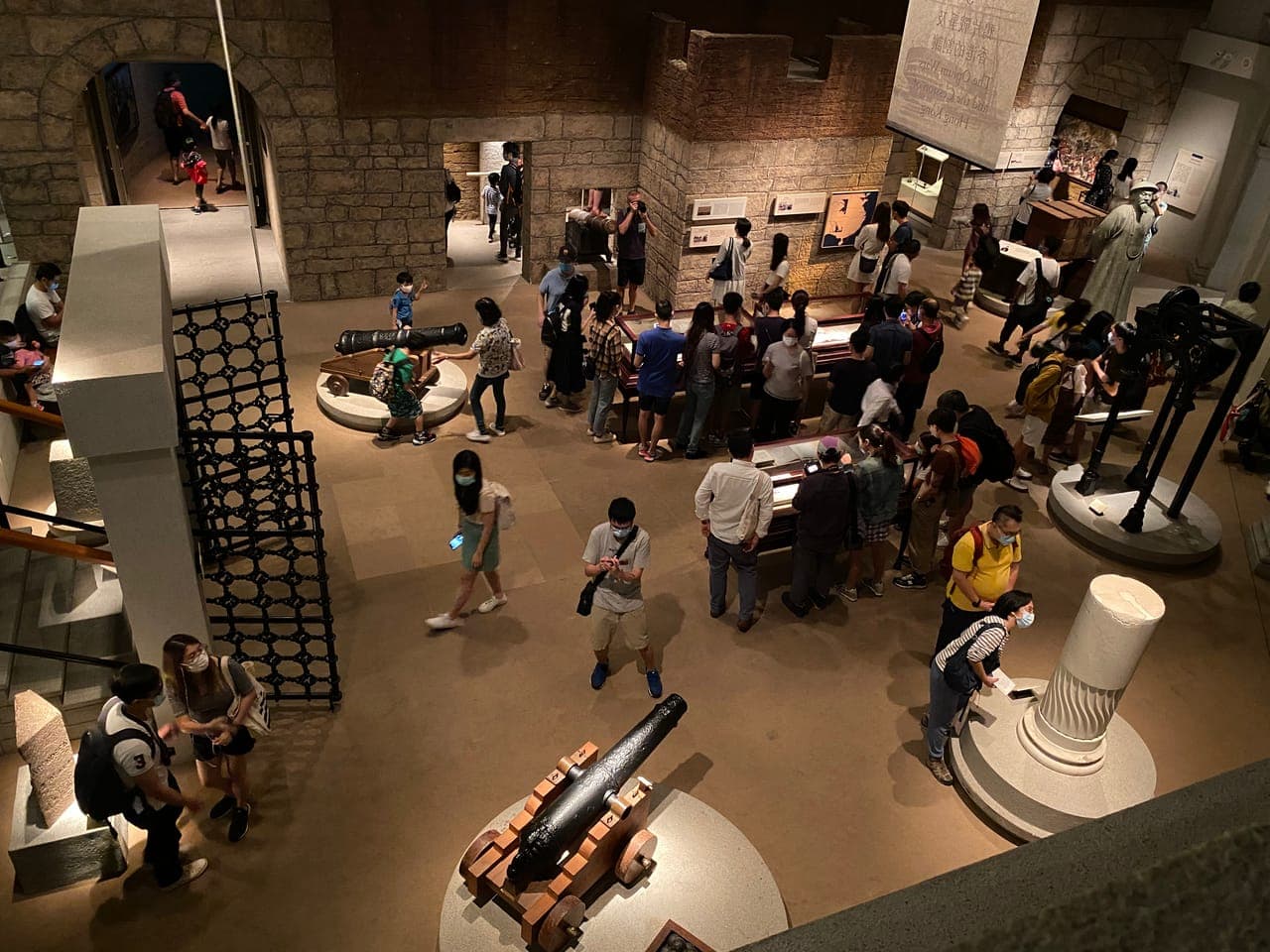 Visitors exploring immersive dioramas and ancient artifacts in the Hong Kong Museum of History's Multifaceted Hong Kong exhibit.