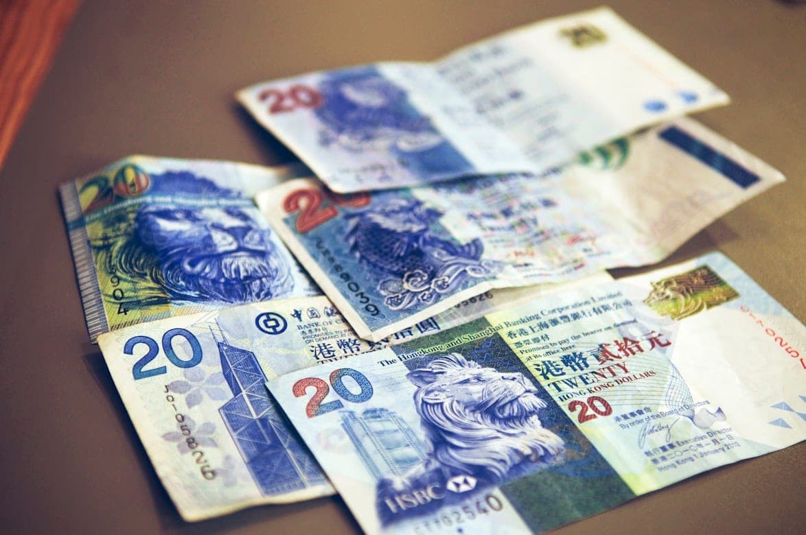 Hong Kong dollar banknotes spread on a table, illustrating travel costs in Hong Kong