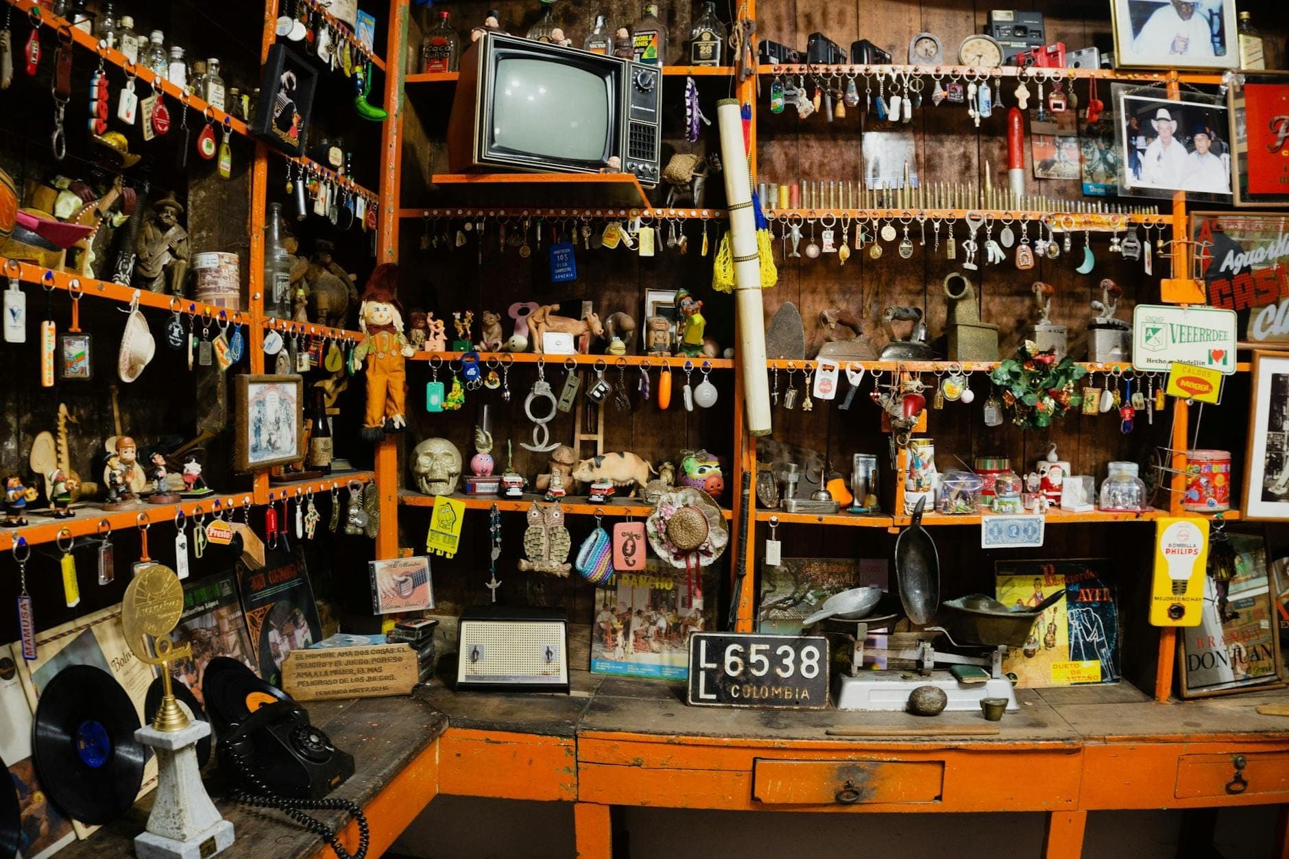Interior view of the New Orleans Historic Voodoo Museum with shelves full of artifacts, talismans, skulls, and ritual objects in a dimly lit room.
