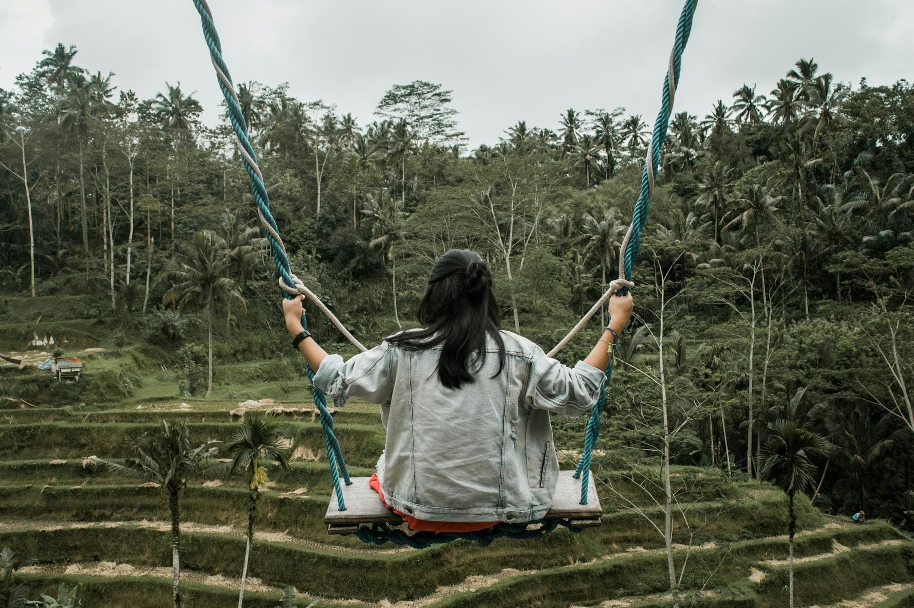 Woman sitting on a swing in Tegallalang Rice Terraces, Ubud