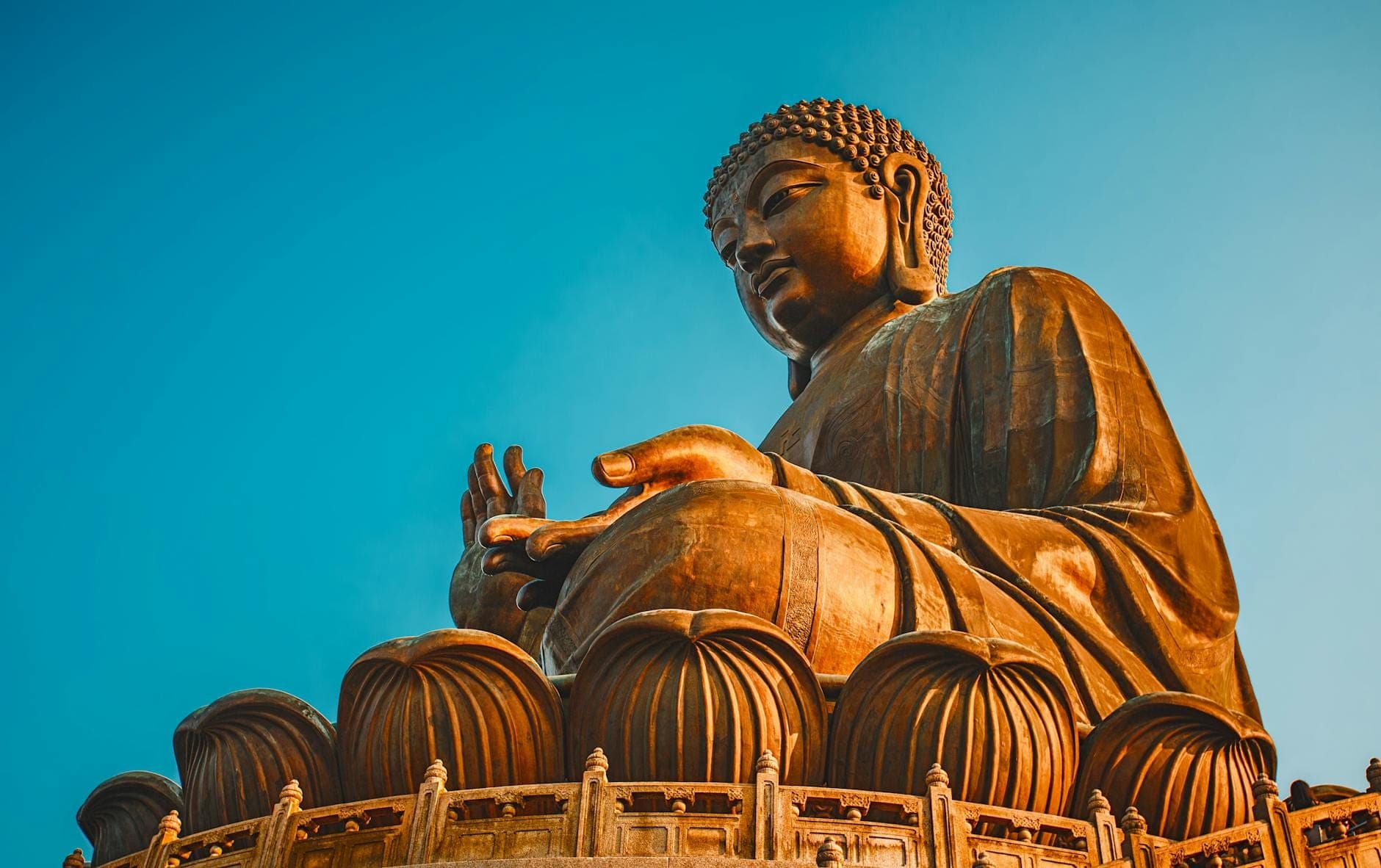 Serene Tian Tan Buddha (Big Buddha) glowing in sunlight evoking peace in Lantau Island, Hong Kong.