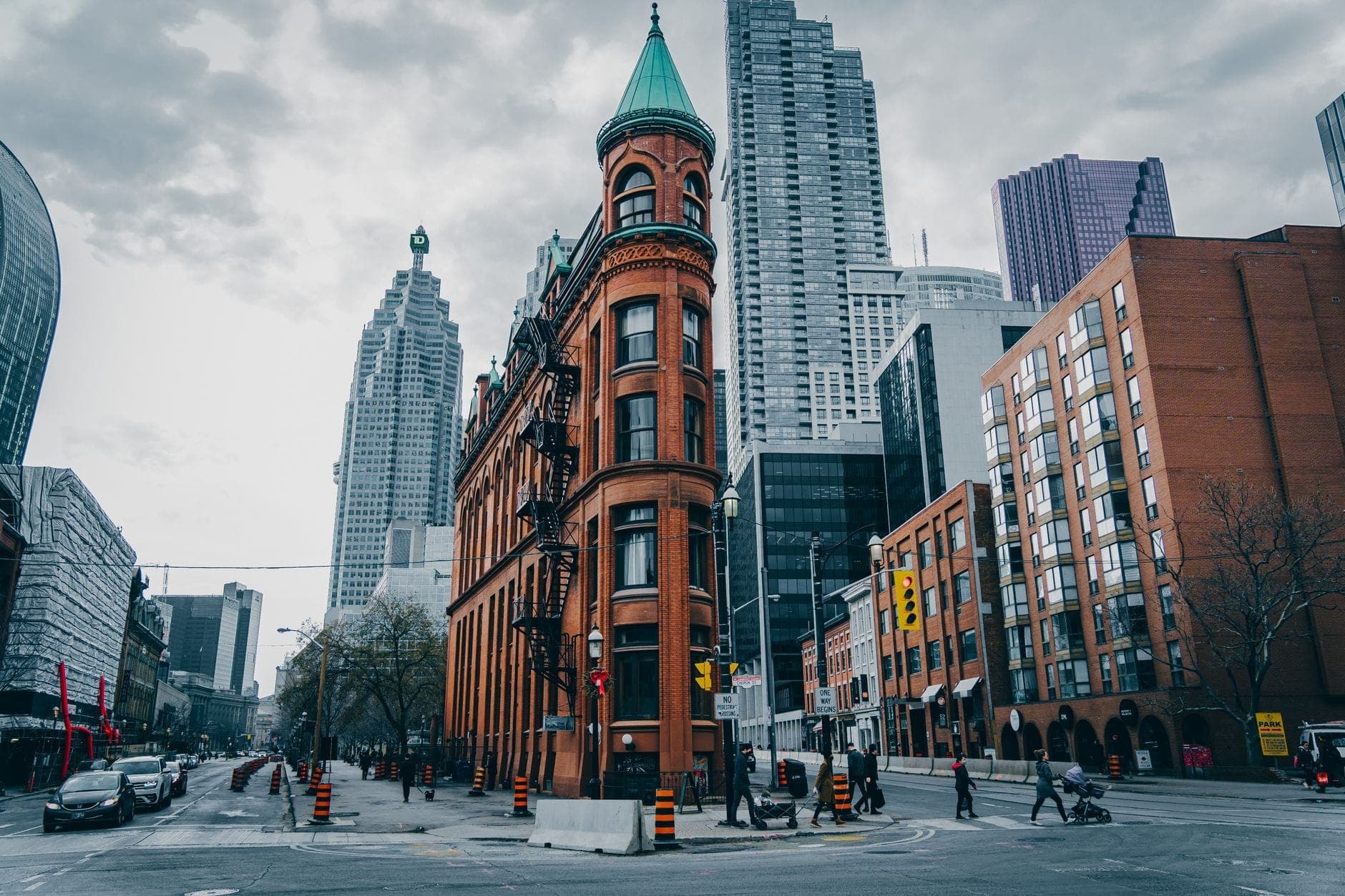 The Gooderham Building with modern skyscrapers in downtown Toronto, illustrating the city’s architectural evolution across eras.