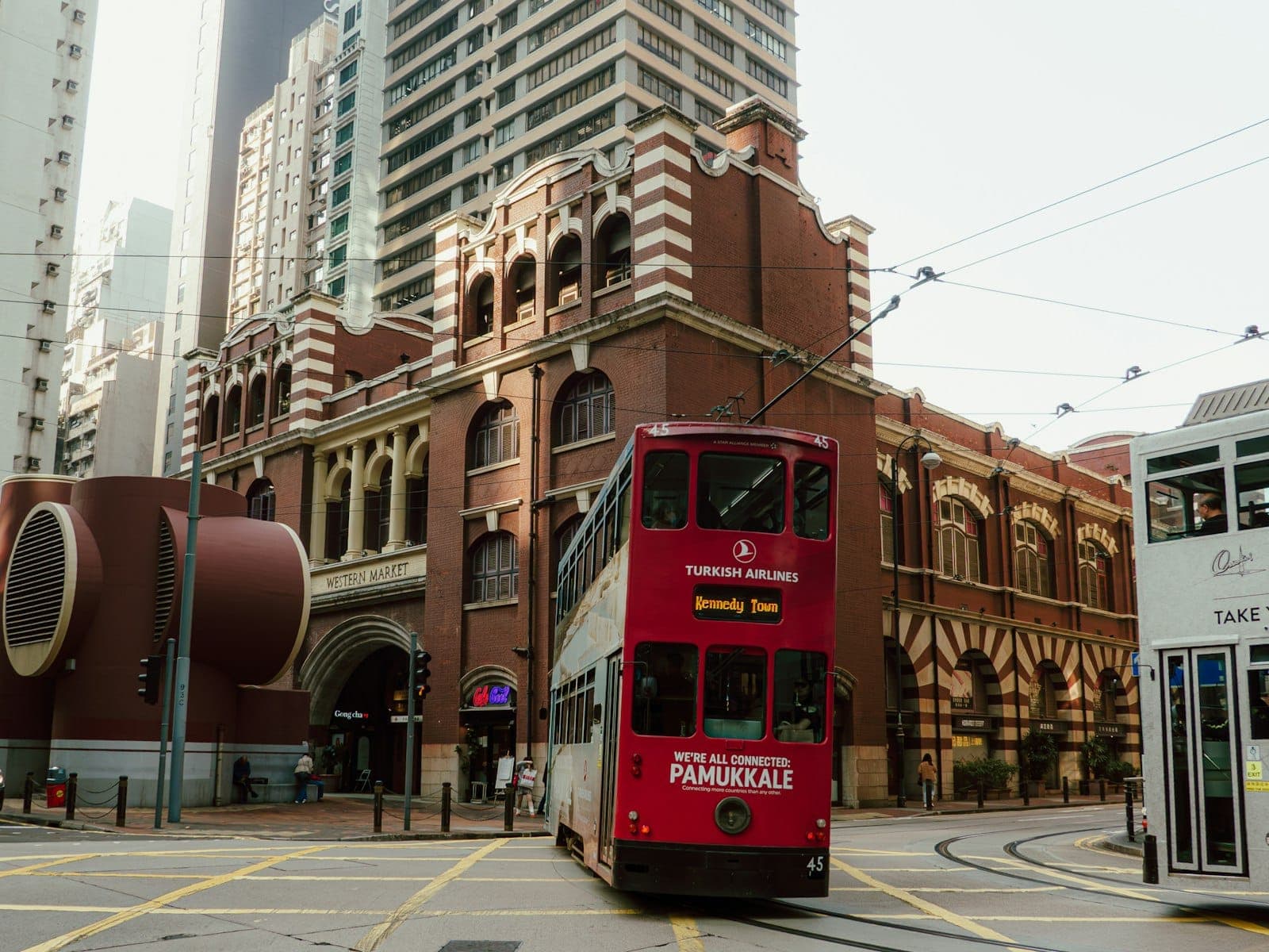 Historic red-brick Western Market building with Edwardian architecture and white-striped corner towers in Sheung Wan, Hong Kong