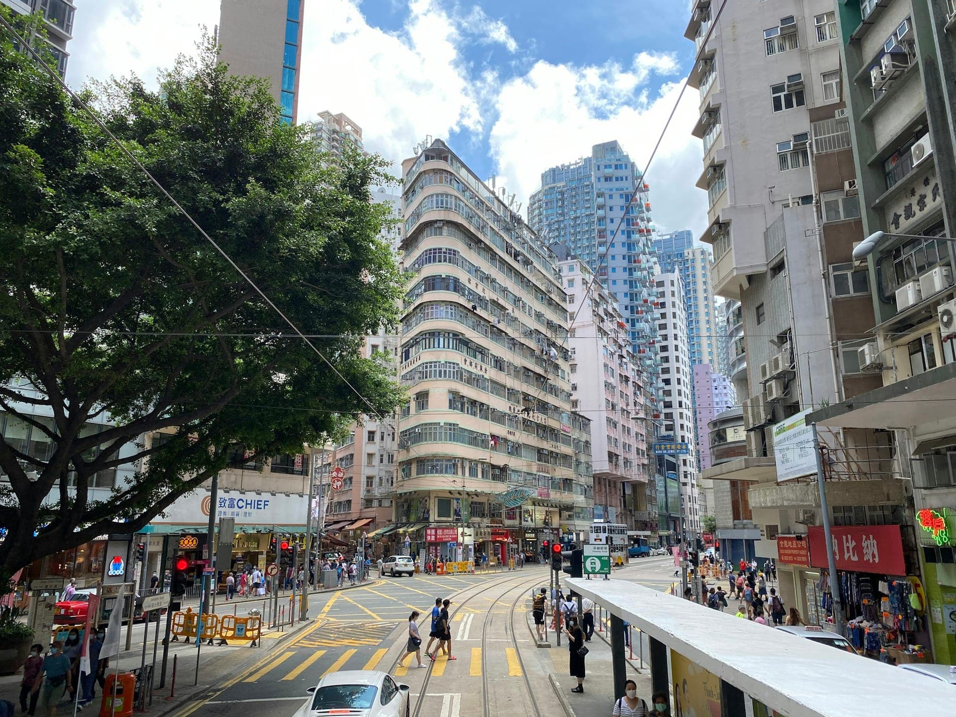 Street scene in Wan Chai Hong Kong near tram lines and local shops and mid-rise buildings