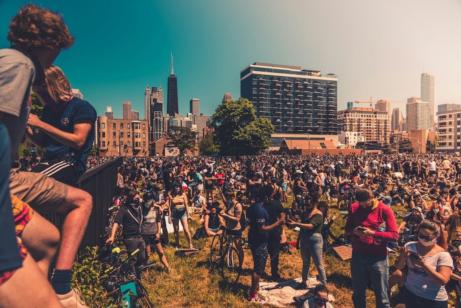 Large outdoor crowd at a festival or event in Chicago, with city skyline and famous skyscrapers visible in the background