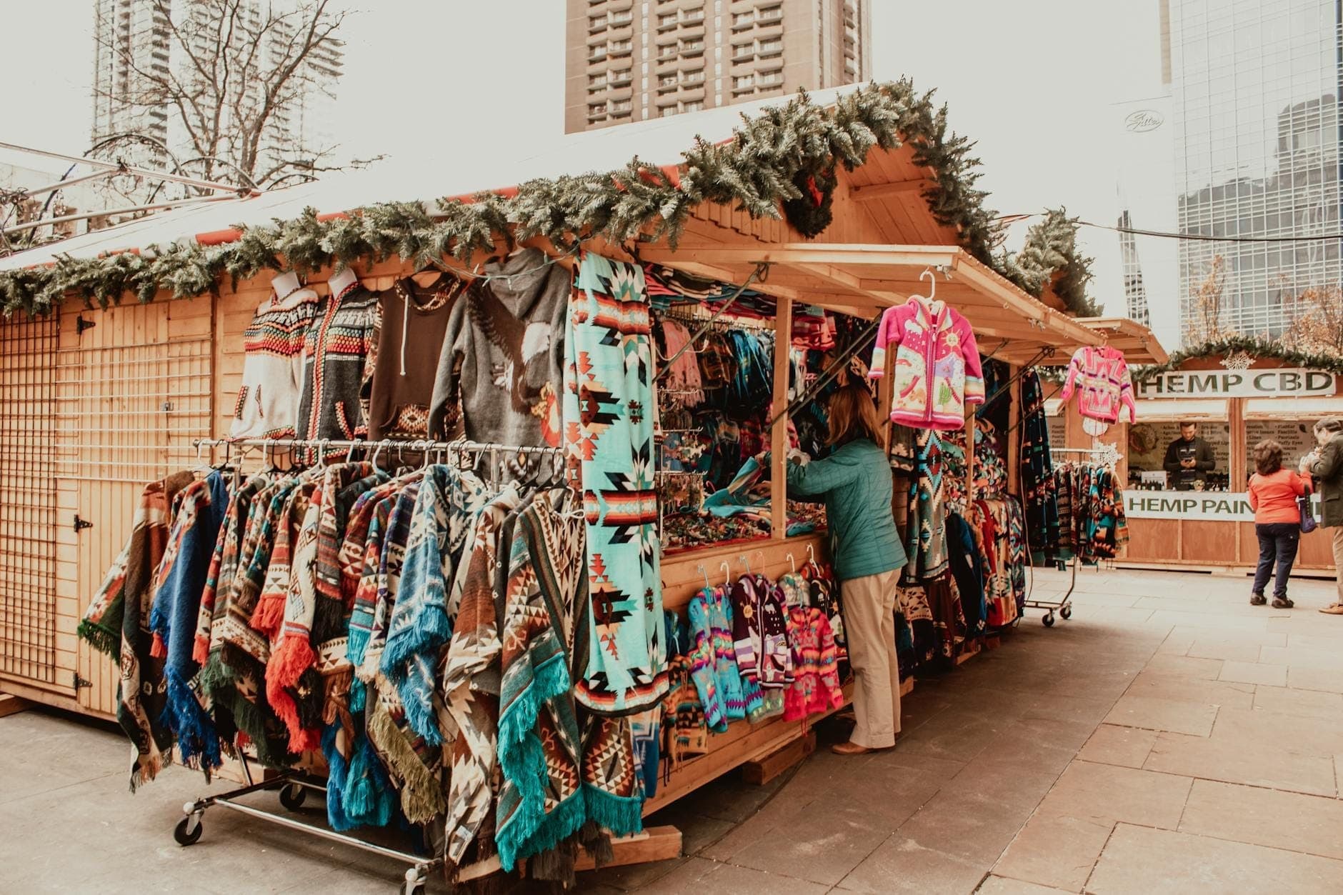 Christmas market stall selling colorful clothes with downtown Chicago skyscrapers in the background
