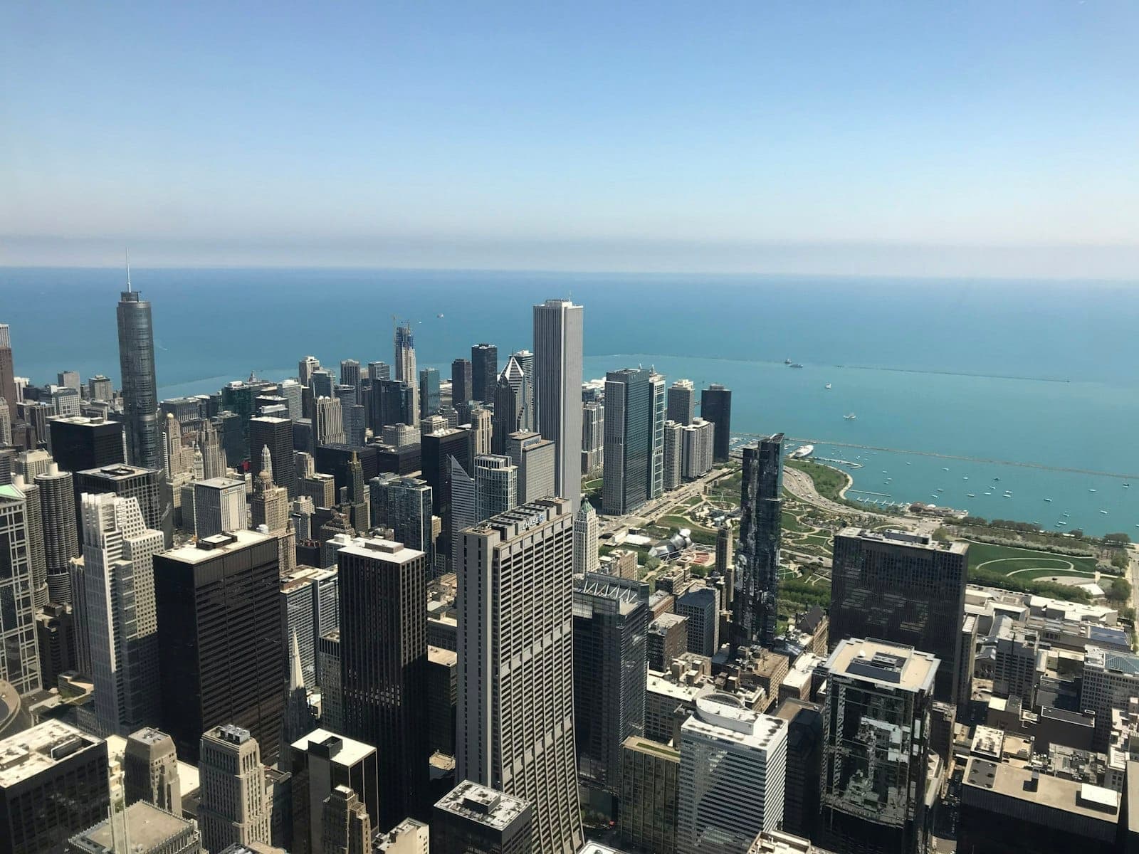 High angle view of downtown Chicago skyscrapers and Lake Michigan from an observation deck on a clear day.