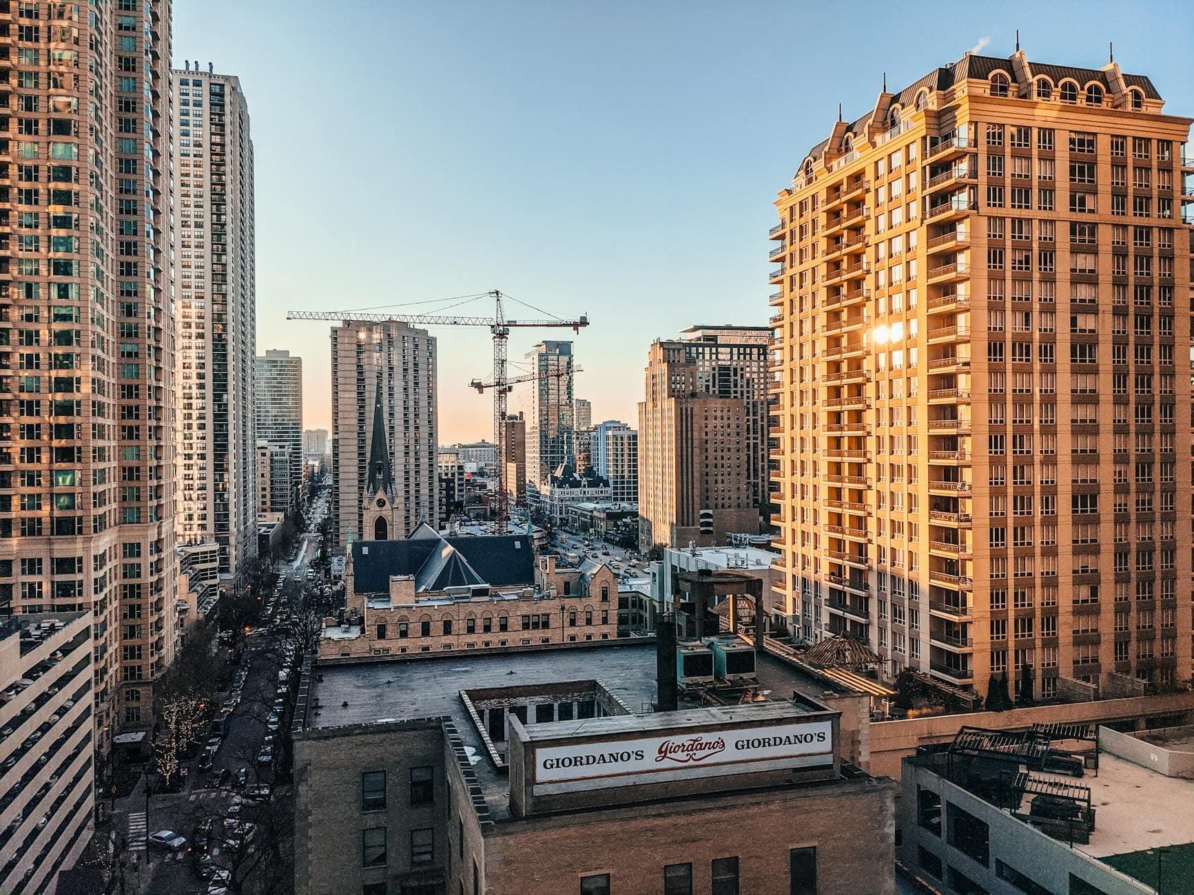 View of upscale high-rise buildings in Chicago’s Gold Coast neighborhood with streets below and luxury residences.