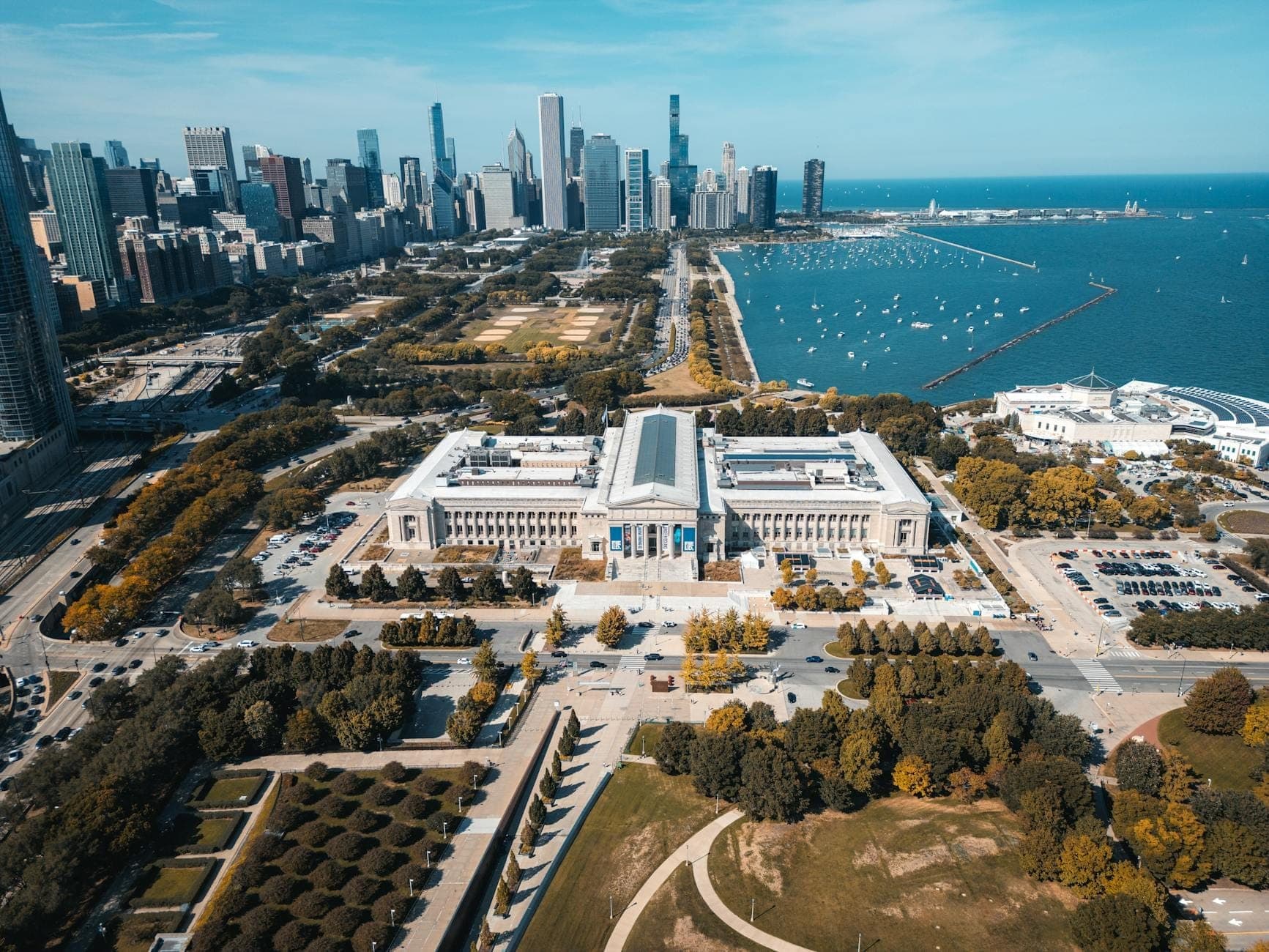 Aerial view of Chicago’s Museum Campus with the skyline and Lake Michigan in the background on a clear day.