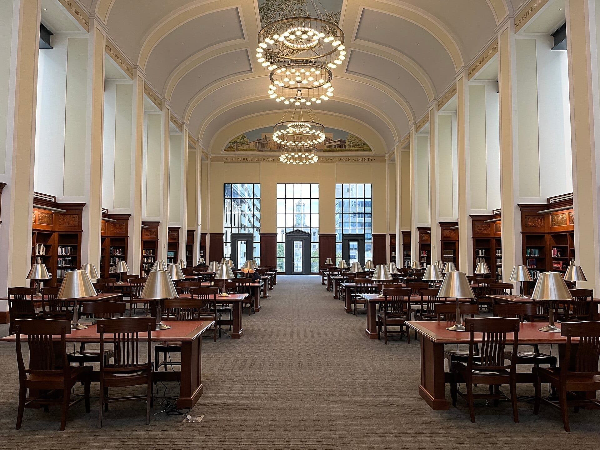 Wide view of the Civil Rights Room at Nashville Public Library, featuring high arched ceilings, wooden tables, and reading lamps.