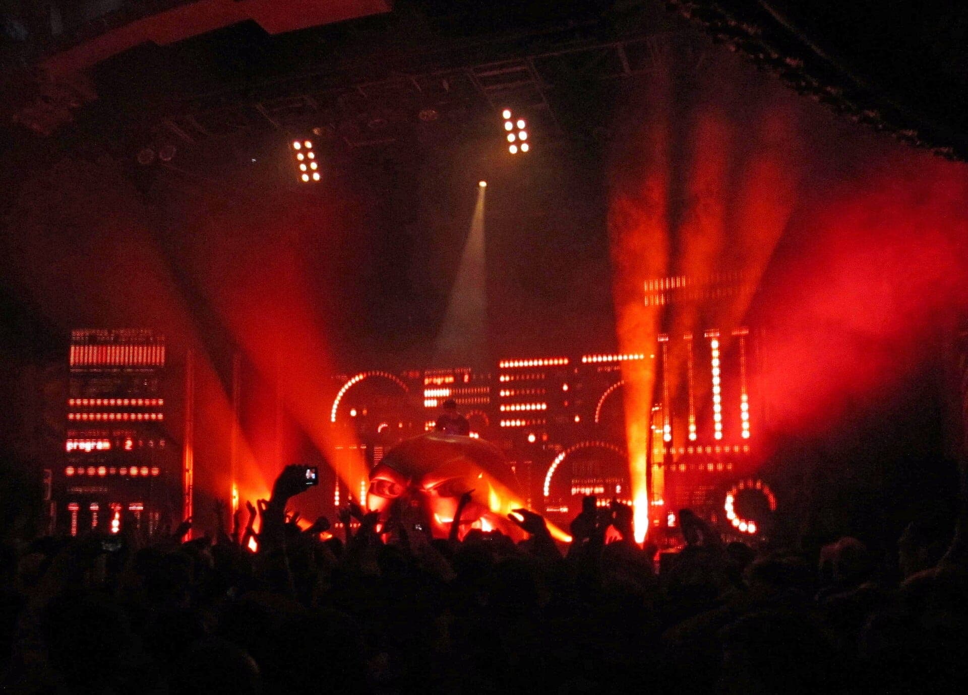 Large crowd enjoying a live music show with dramatic red and orange lights at House of Blues Chicago.