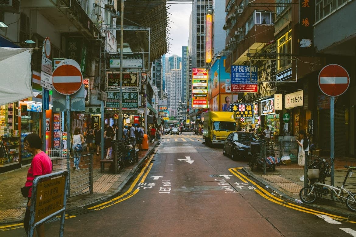 Street scene in a busy Hong Kong neighborhood showing local shops and everyday life