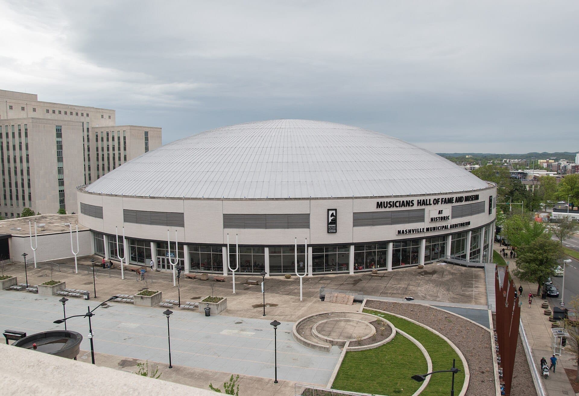 Exterior view of the Musicians Hall of Fame & Museum at Nashville Municipal Auditorium, featuring its large domed roof and modern concrete plaza.