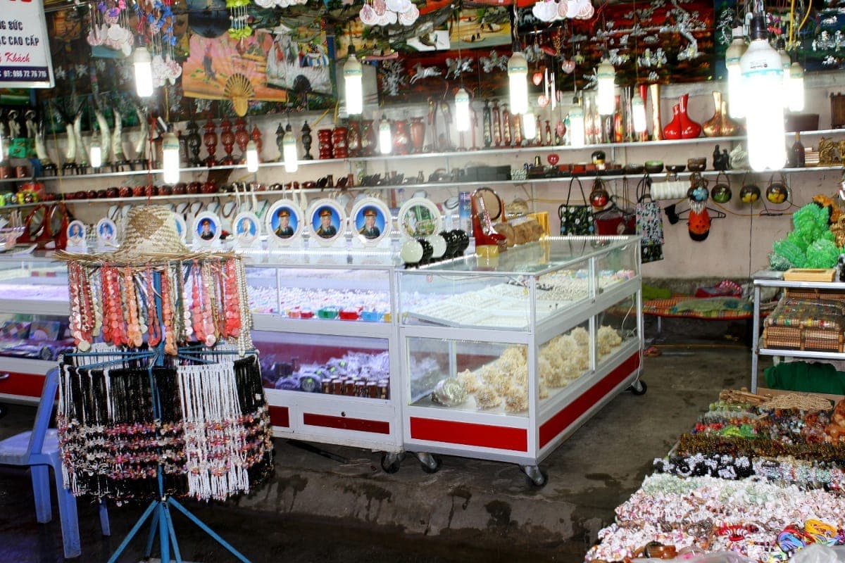 Phu Quoc Gece Pazarı'nda inci takı vitrinleri, hediyelikler ve parlak aydınlatılmış bir dükkân