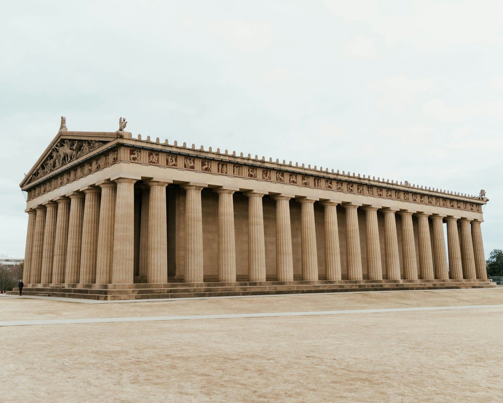 Wide-angle view of the Nashville Parthenon in daylight, showcasing the full-scale replica’s grand Doric columns and architectural details against a bright sky.