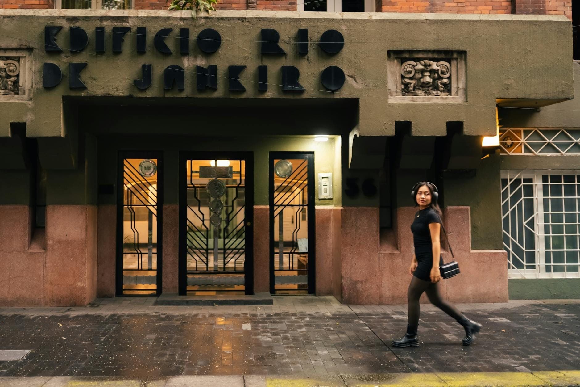 Art deco facade of Edificio Rio de Janeiro in Roma Norte with a woman walking by on the sidewalk