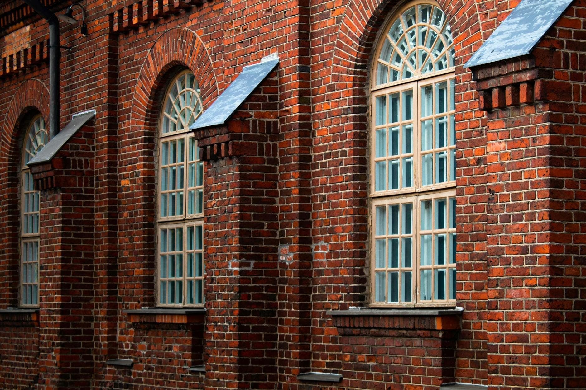 Historic brick building with tall arched windows and detailed masonry, representing Germantown’s 19th-century architecture in Nashville.