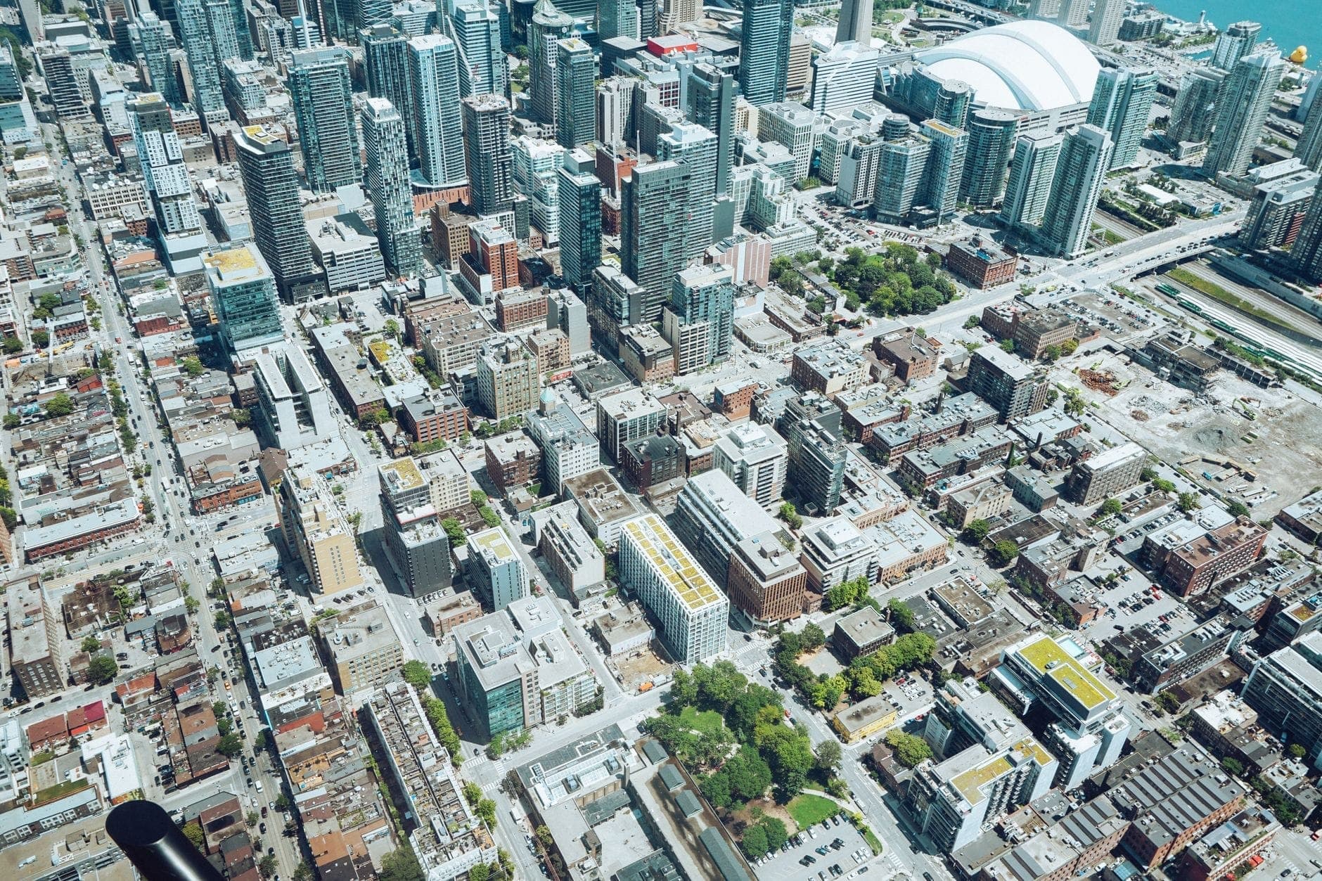 Aerial view of downtown Toronto showing distinct neighbourhood blocks and major buildings, including the Rogers Centre and nearby high-rises.