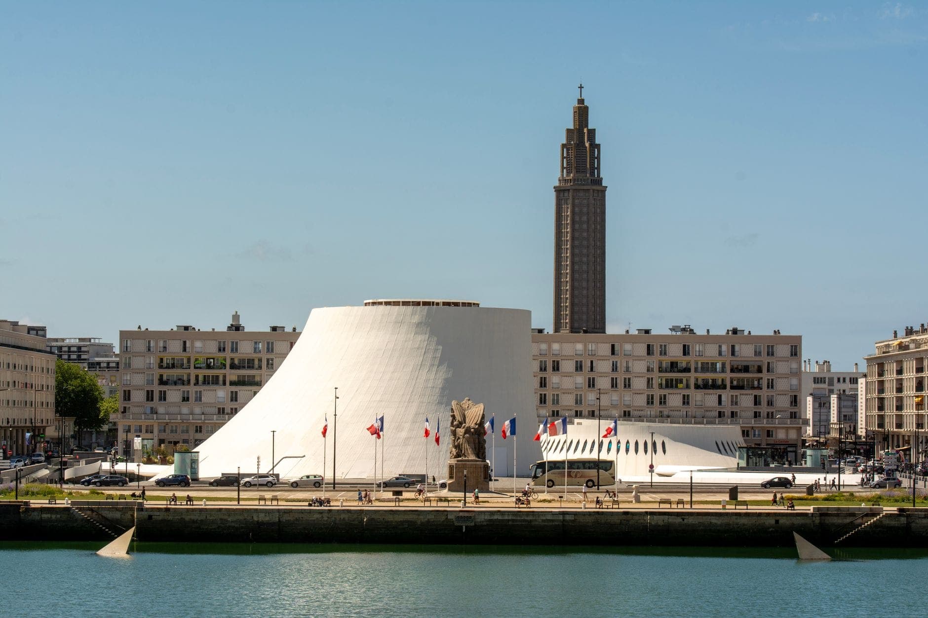 Toàn cảnh trung tâm hiện đại Le Havre với nhà văn hóa Le Volcan màu trắng, nhà thờ St. Joseph nổi bật cạnh bờ biển dưới bầu trời trong.